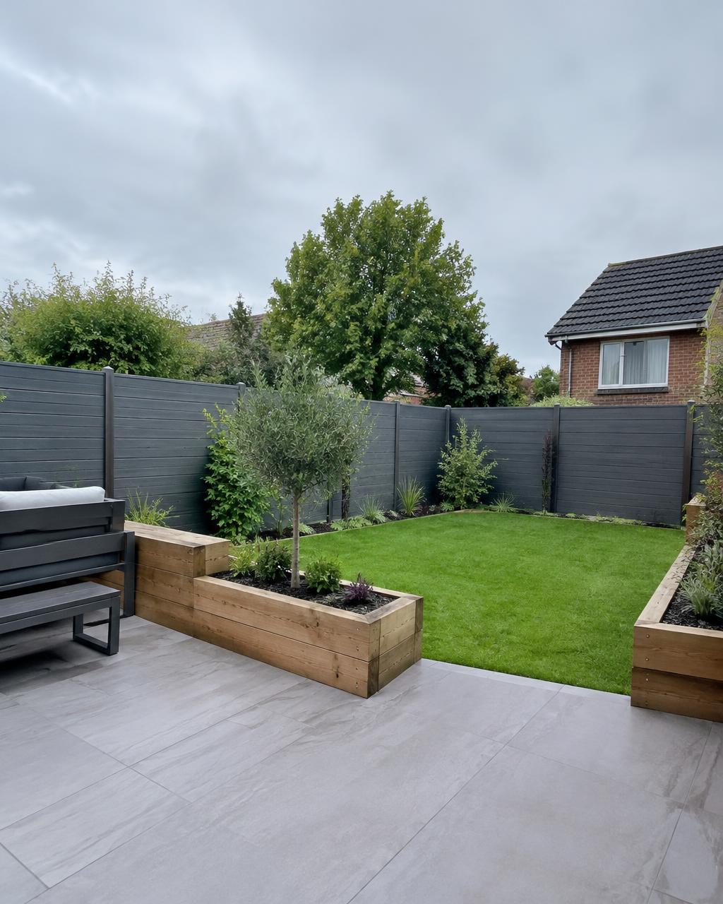 Porcelain patio with timber raised planters and lawn